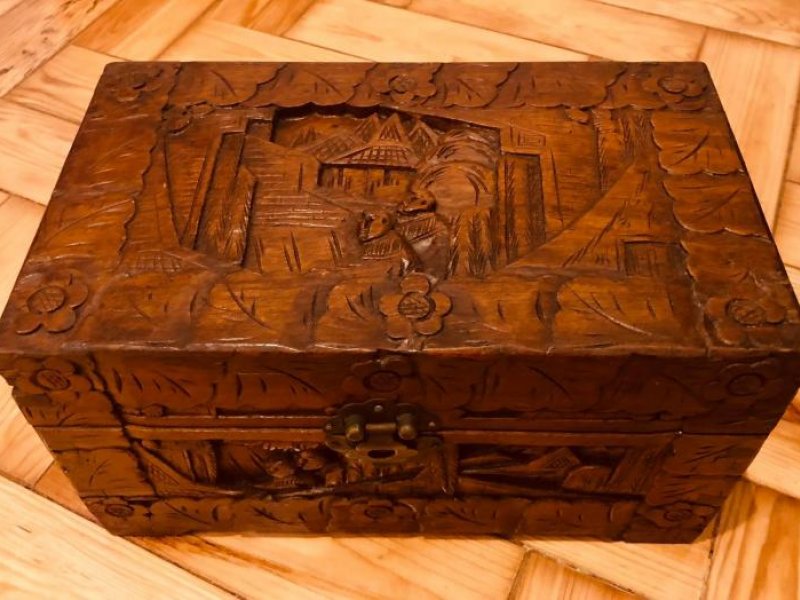 Oriental camphor wood chest decorated with bas-relief
